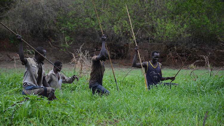 Opo men fishing with spears.
